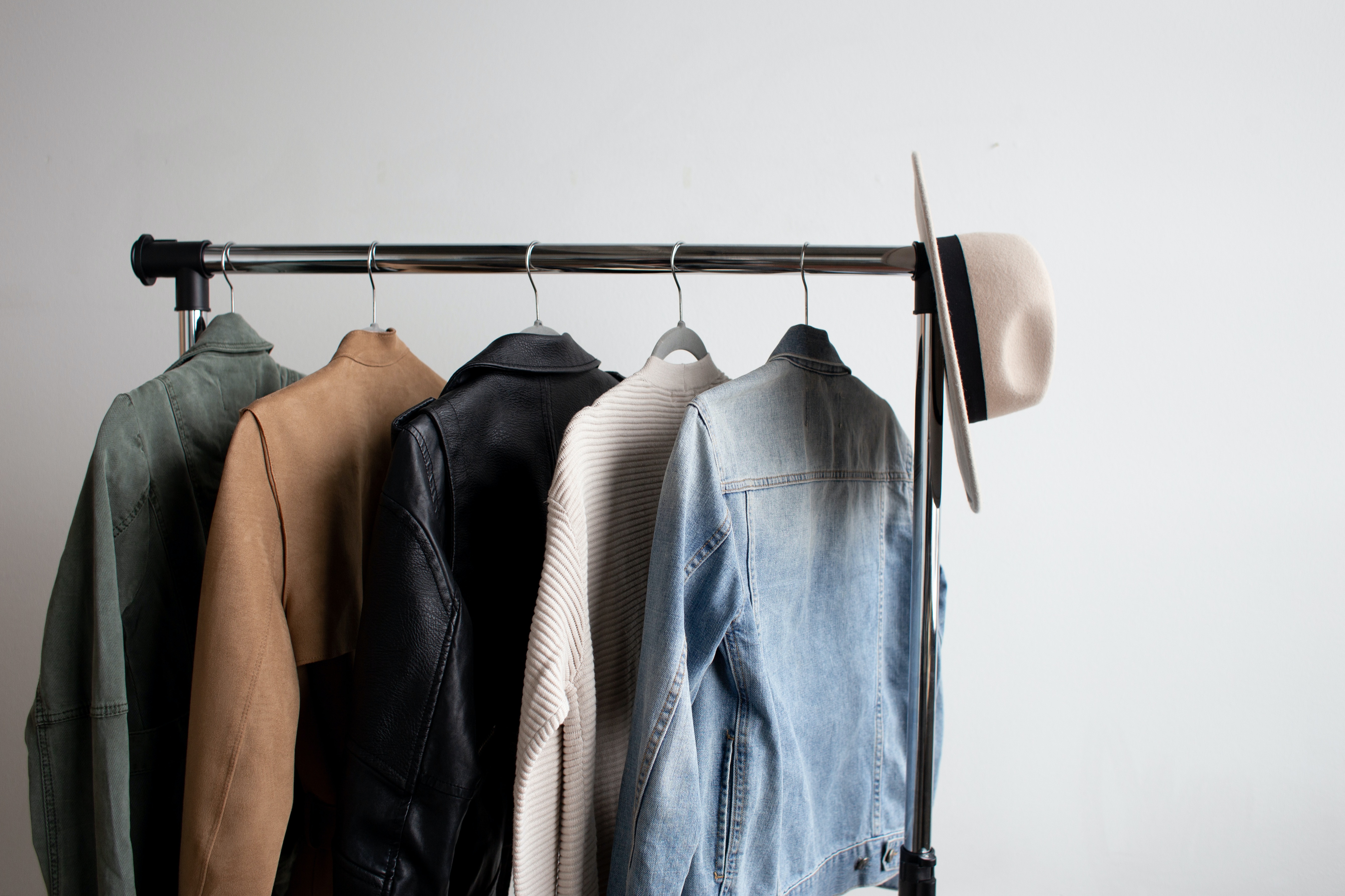 a rack of clothes with a hat and jacket on it